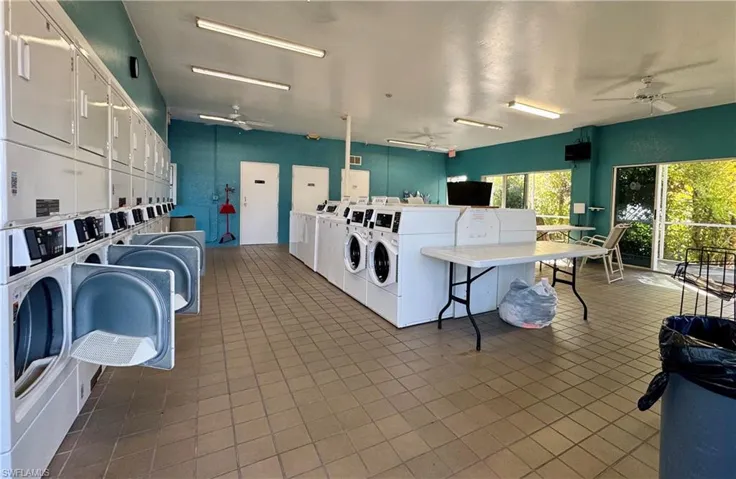 Shared laundry room featuring ceiling fan and washer and dryer