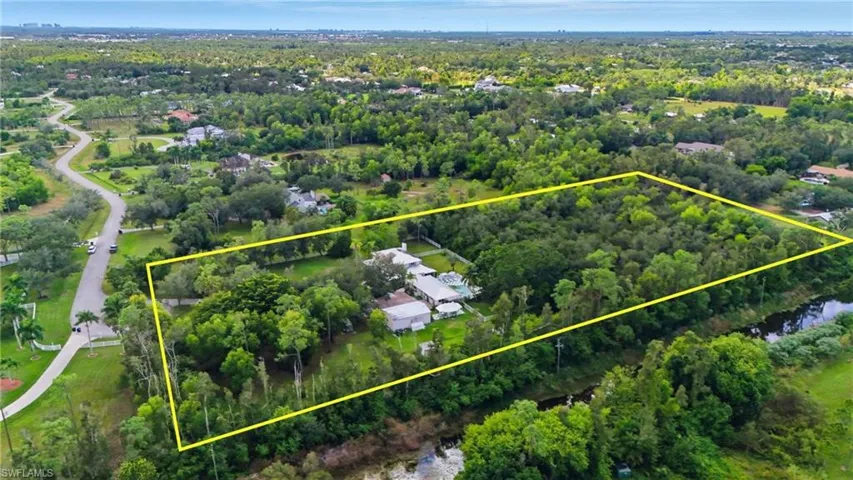 Aerial overview of property's location with a nearby body of water and property boundaries highlighted - Virtually Edited Image