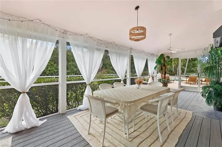 Sunroom featuring hardwood / wood-style floors - Virtually Edited Image