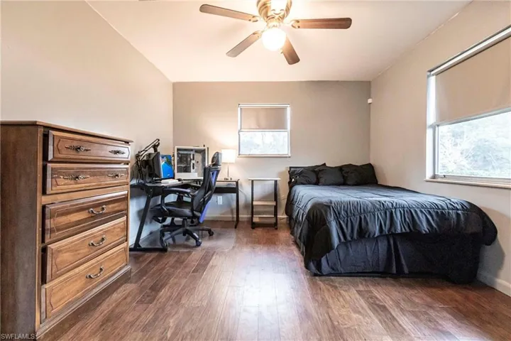 Bedroom featuring ceiling fan and dark hardwood / wood-style floors