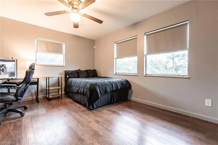 Bedroom with ceiling fan and hardwood / wood-style floors