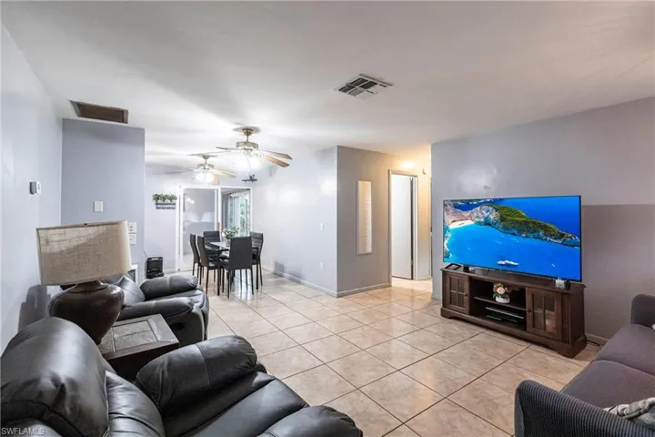 Tiled living room featuring ceiling fan