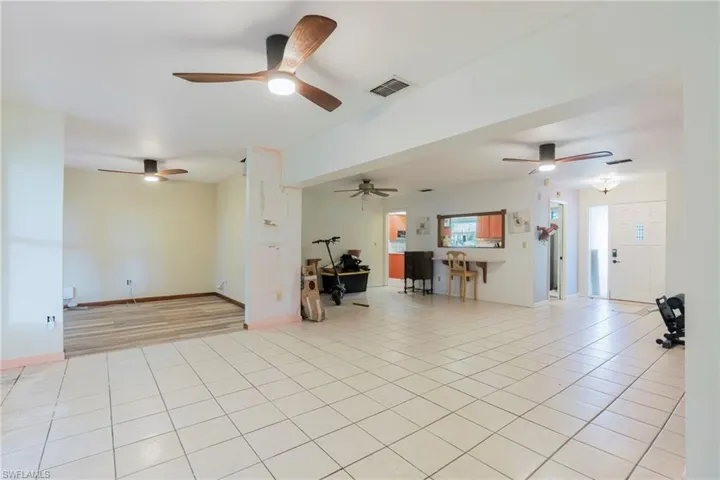 Living area featuring light tile patterned floors and baseboards