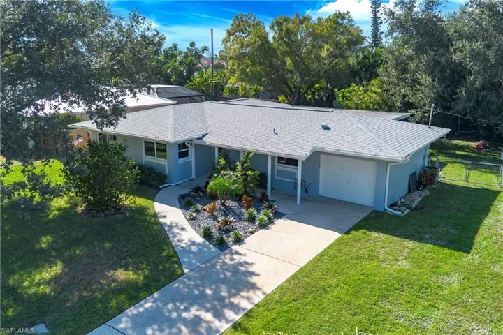 View of front of house featuring stucco siding, driveway, and an attached garage