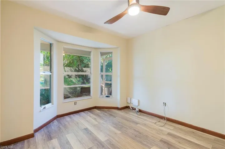 Spare room featuring light wood-style flooring and ceiling fan