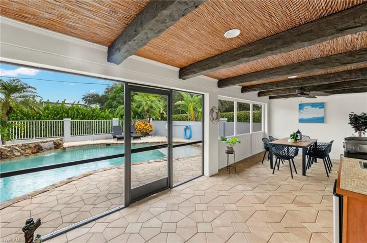 Unfurnished sunroom featuring beamed ceiling and wooden ceiling