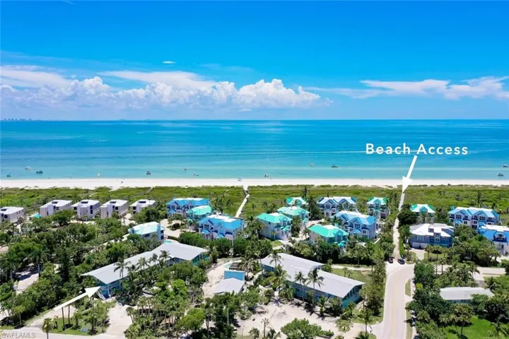 Drone / aerial view with a beach view and a water view