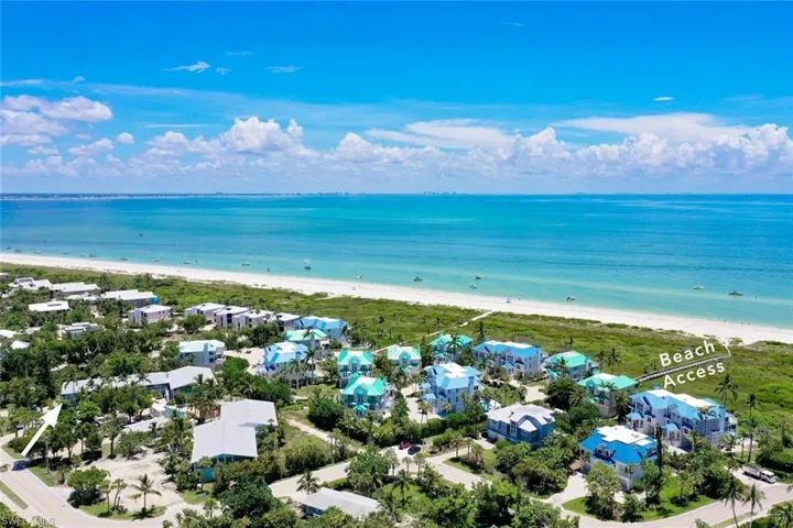 Aerial view with a water view and a beach view