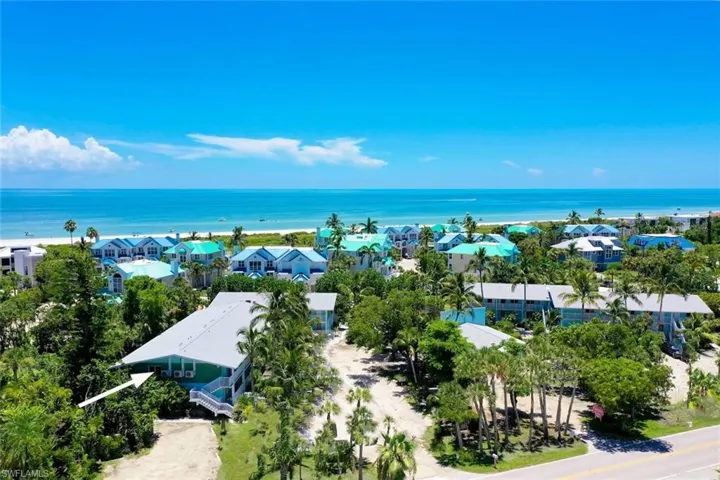 Birds eye view of property with a water view