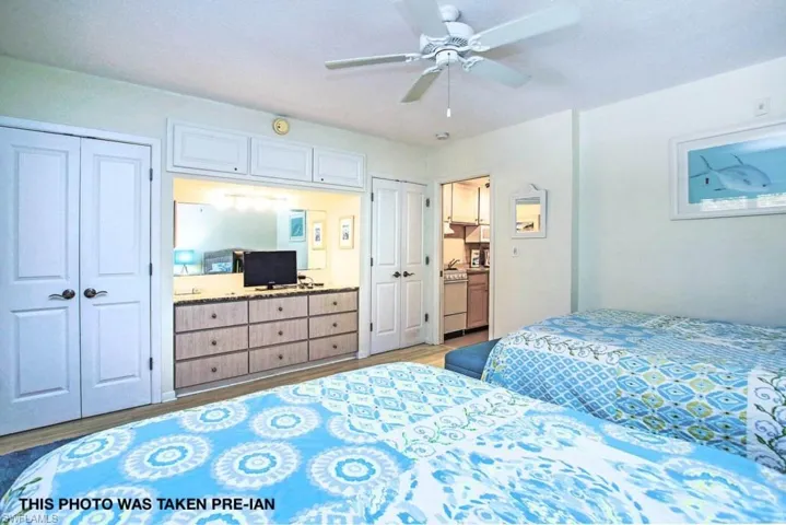Bedroom featuring two closets, ceiling fan, and light hardwood / wood-style flooring