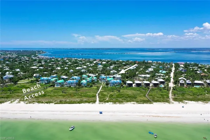 Aerial view with a water view and a beach view