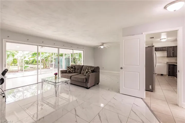 Living room looking toward dining and kitchen. Check out that full slider view!