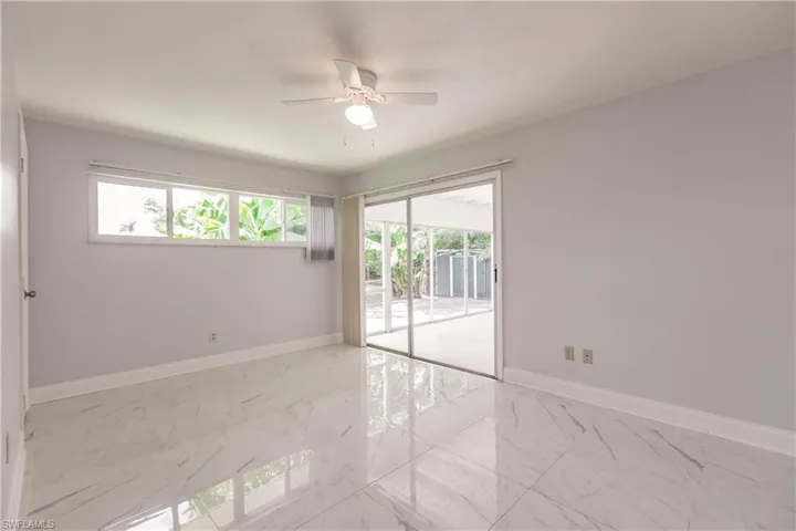 fully tiled Primary suite with sliders to lanai