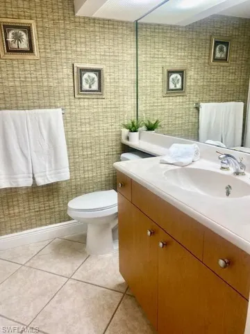 Bathroom featuring tile patterned floors, vanity, and toilet