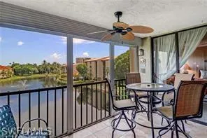 Sunroom featuring a water view and ceiling fan