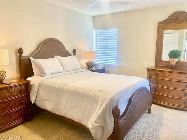 Bedroom featuring a ceiling fan and light carpet