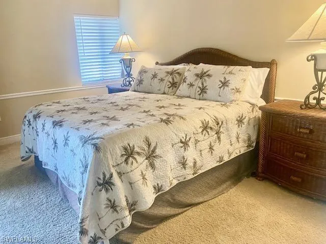Carpeted bedroom featuring baseboards