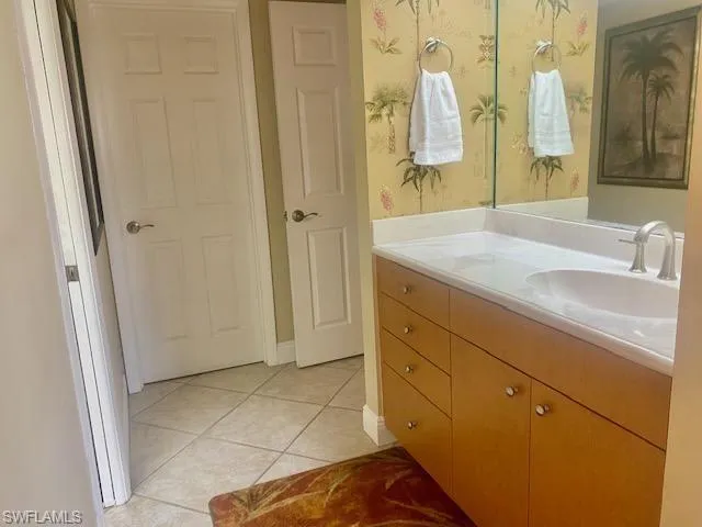 Bathroom featuring tile patterned flooring and vanity