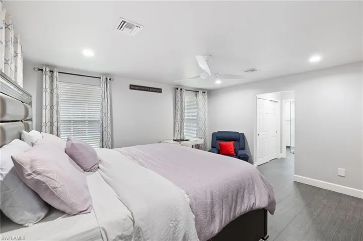 Bedroom featuring dark hardwood / wood-style floors and ceiling fan