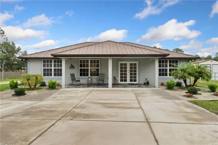 Rear view of property with covered porch