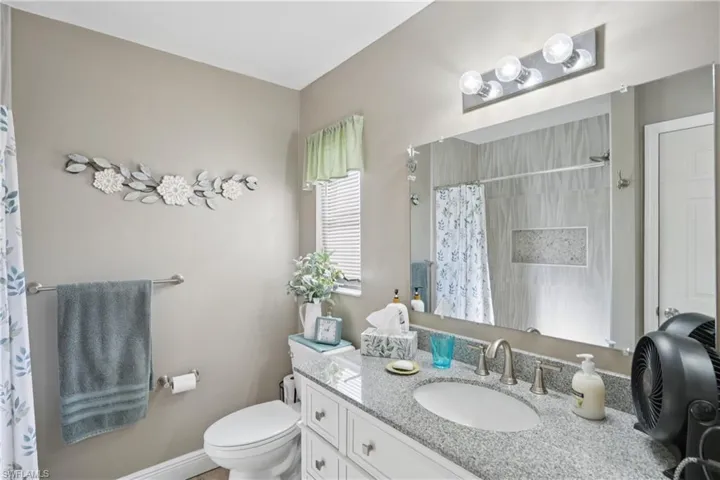 Full bathroom featuring vanity and a shower with shower curtain