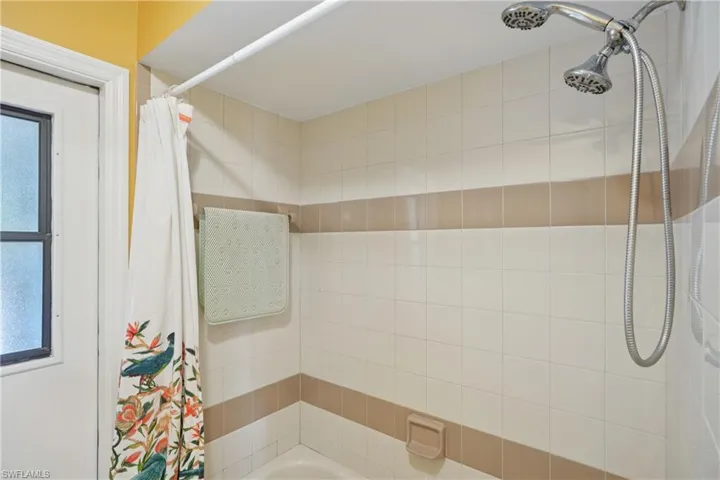 Bathroom featuring shower / bath combination with curtain