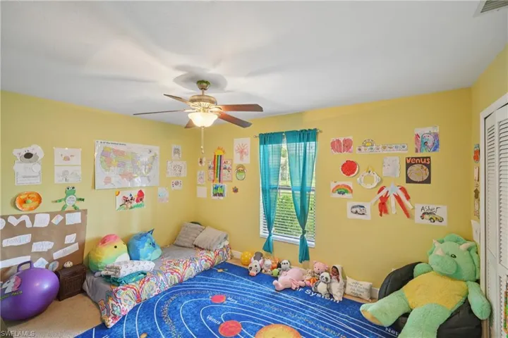 Bedroom featuring a ceiling fan, a closet, and carpet flooring