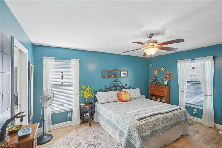 Bedroom with a ceiling fan and wood finished floors