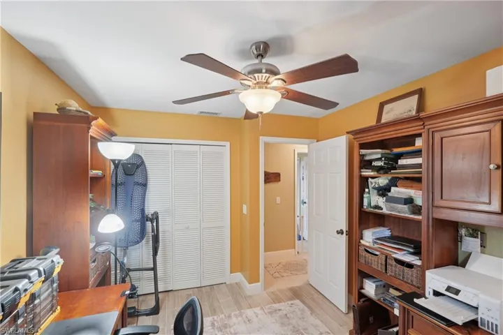Office space with ceiling fan and light wood-style floors