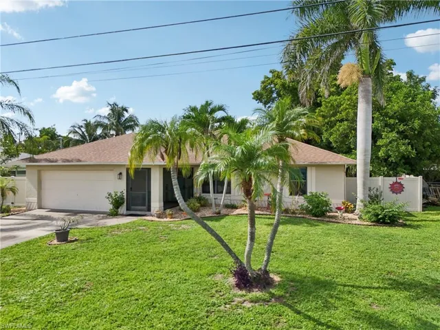 Ranch-style house featuring concrete driveway, stucco siding, and an attached garage