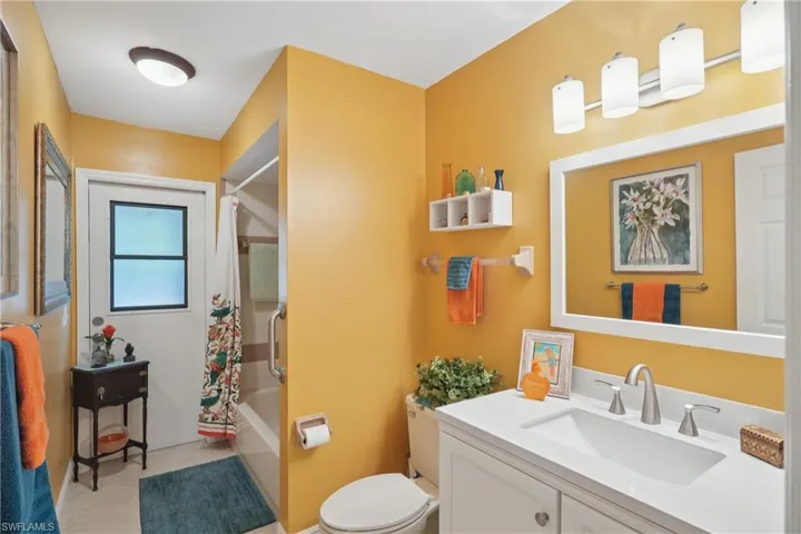 Bathroom featuring vanity and shower / tub combo with curtain