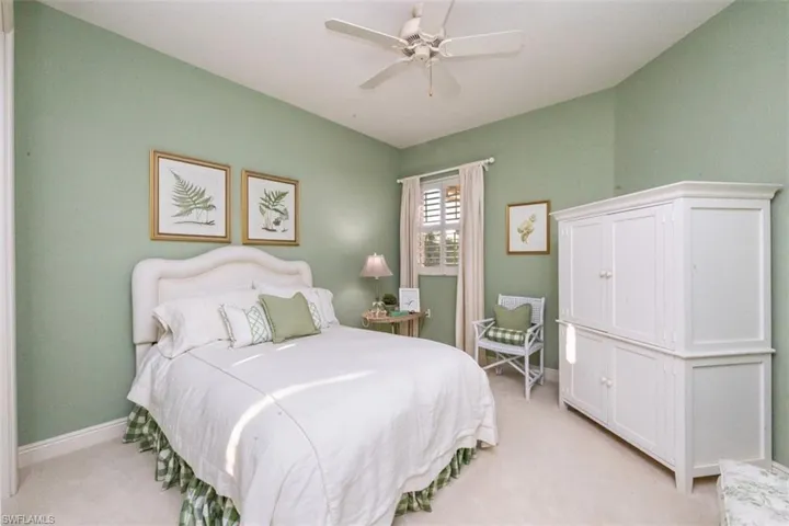 Bedroom featuring light carpet and a ceiling fan