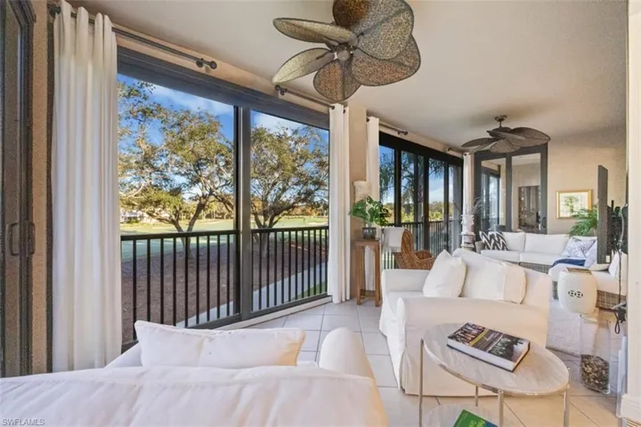 Sunroom / solarium featuring a water view, tile patterned flooring, and healthy amount of natural light