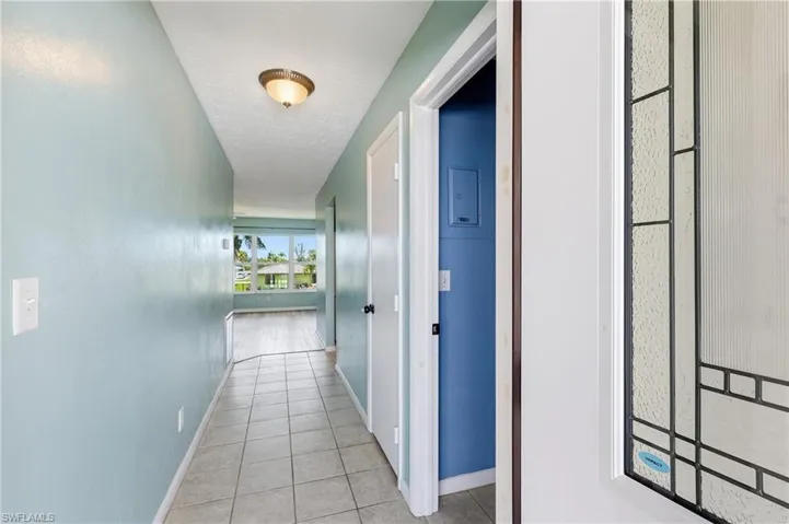 View when entering via front door. Laundry room is first door on the right, coat closet is next, and then the kitchen, followed by the dining room/living room and wonderful southern view.