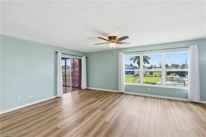 Beautiful new, tilt in, living room windows are impact resistant for protection in storms and to reduce noise. Sliders on left provide access to all season lanai and back stairway.
