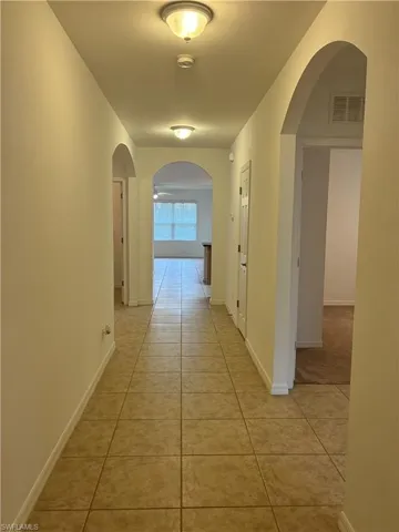 Entrance Hall  featuring arched walkways and light tile patterned floors
