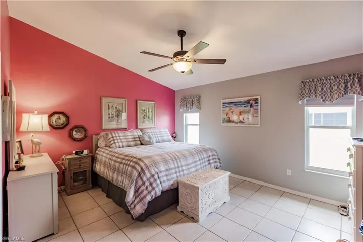 Tiled bedroom featuring lofted ceiling