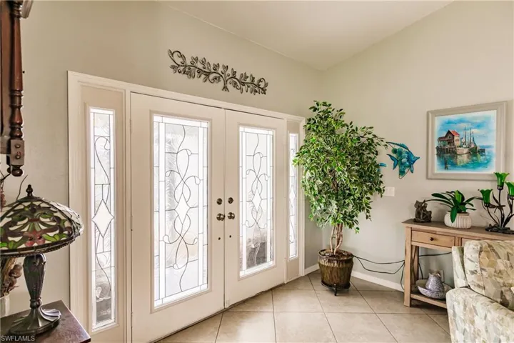Tiled entrance foyer featuring french doors and plenty of natural light