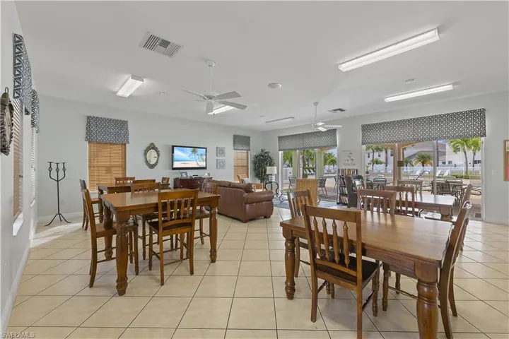 Dining room with light tile patterned floors and ceiling fan