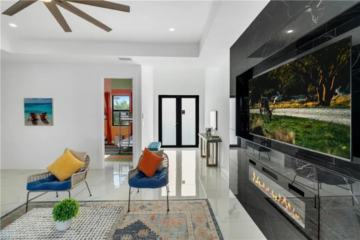 Living area with recessed lighting and a glass covered fireplace