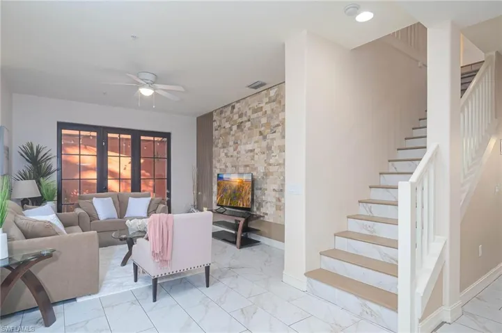Living room featuring ceiling fan and french doors