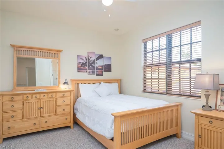 Bedroom featuring light colored carpet and ceiling fan