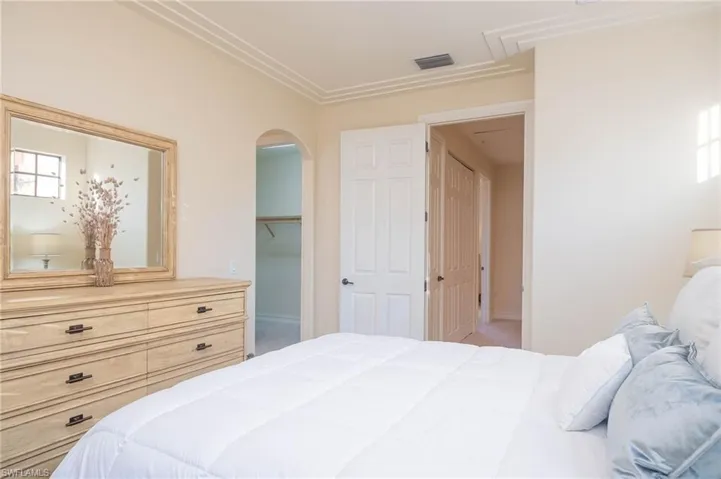 Bedroom with a walk in closet, carpet floors, and a closet