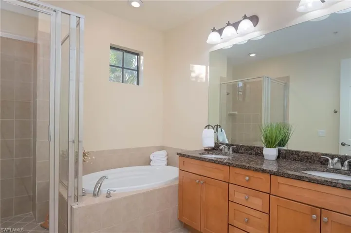 Bathroom with vanity and plus walk in shower