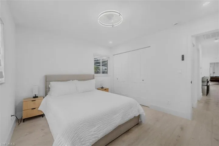 Bedroom with light wood-style flooring and a closet