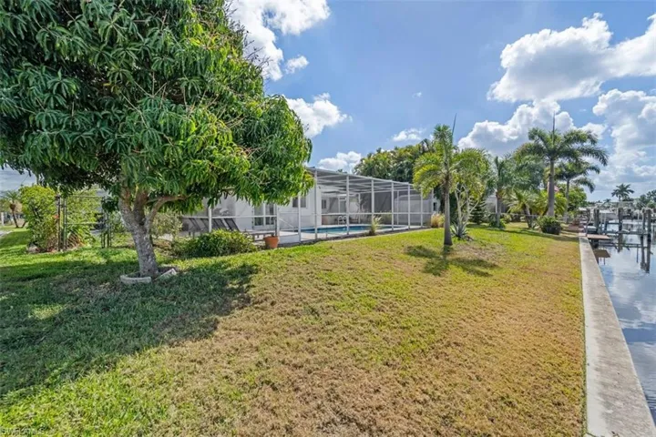 View of community with a sunroom and a pool