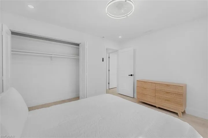 Bedroom with recessed lighting, a closet, and light wood-style floors