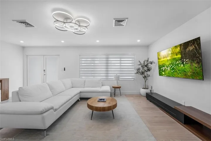 Living room featuring wood finished floors and recessed lighting
