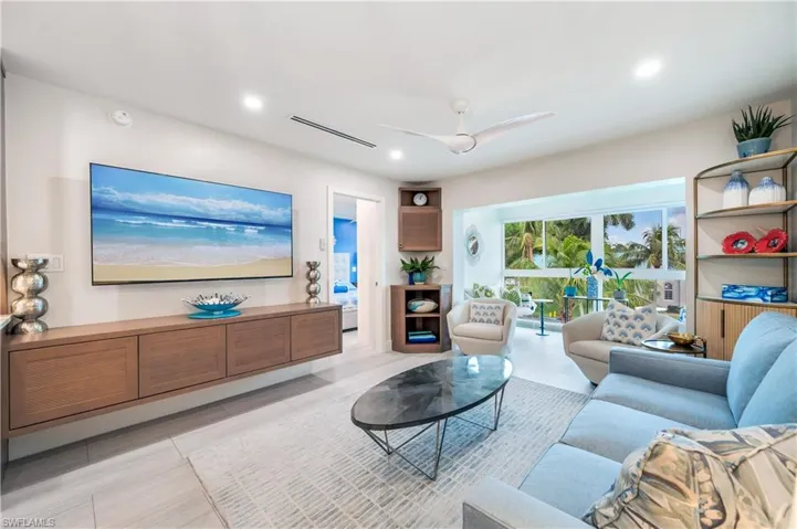 Living room featuring a ceiling fan and recessed lighting