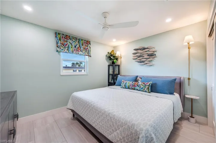 Bedroom with ceiling fan and recessed lighting